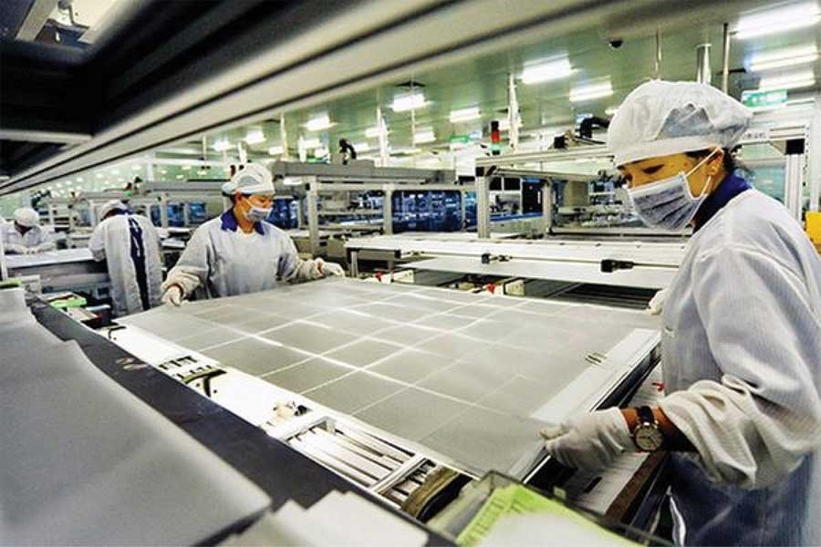 China has issued new standards for photovoltaic (PV) manufacturers. Two women operate on a production line of a solar panel making company in Shangrao, East China's Jiangxi province. 	— Photo courtesy: China Daily