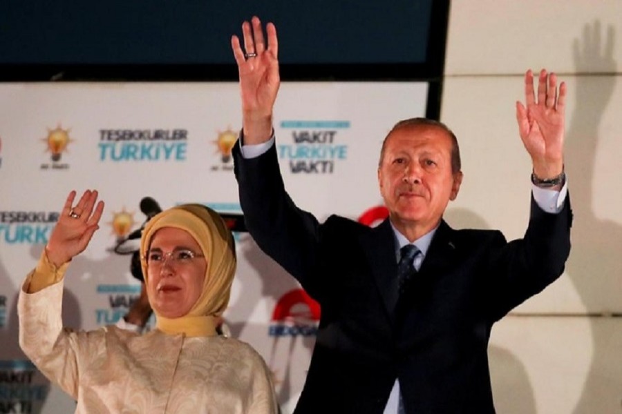 Turkish President Tayyip Erdogan and his wife Emine Erdogan greet supporters gathered in front of the AKP headquarters in Ankara, Turkey, June 25, 2018. Reuters