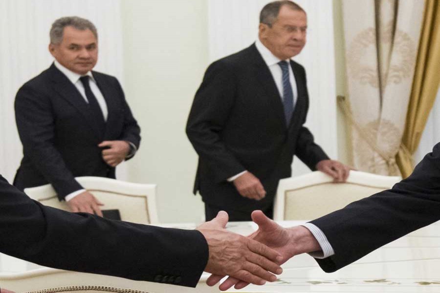 Russian President Vladimir Putin, left, shakes hands with US National security adviser John Bolton with Russian Defense Minister Sergei Shoigu, and Russian Foreign Minister Sergey Lavrov in the background, during their meeting in the Kremlin in Moscow, Russia, Wednesday, June 27, 2018. - AP