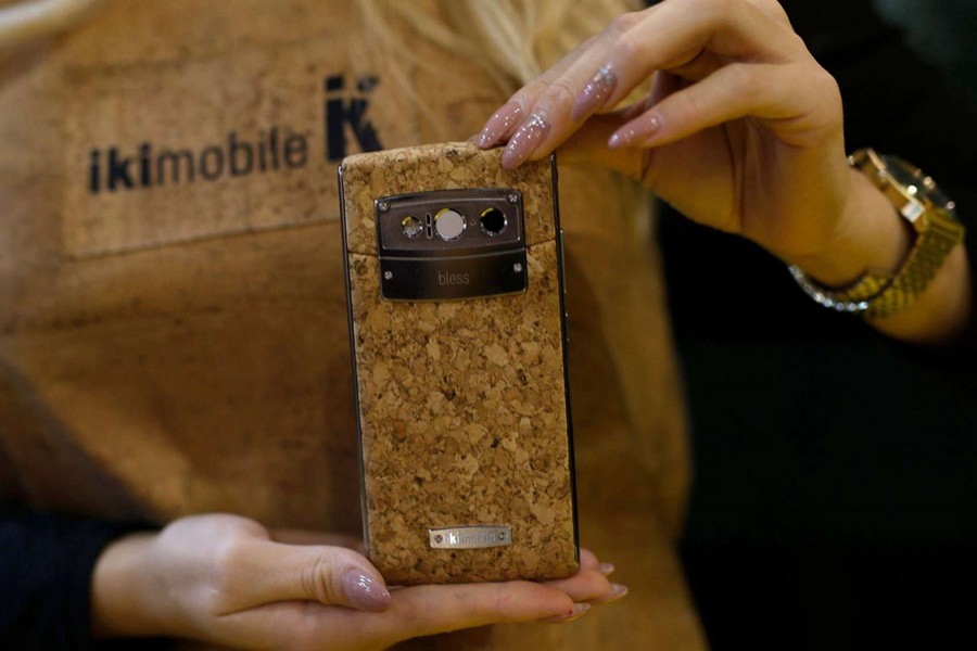 A woman holds the Bless Plus smartphone by Portugal's Ikimobile and which is partially made of cork. Internet photo