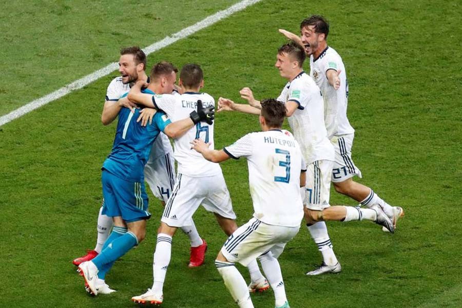Russian players rejoice victory after goalkeeper Akinfeev saves spot-kicks from Koke and Aspas of Spain.