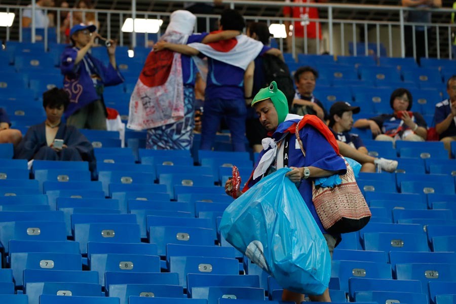 Heartbroken Japan fans clean stadium in tears