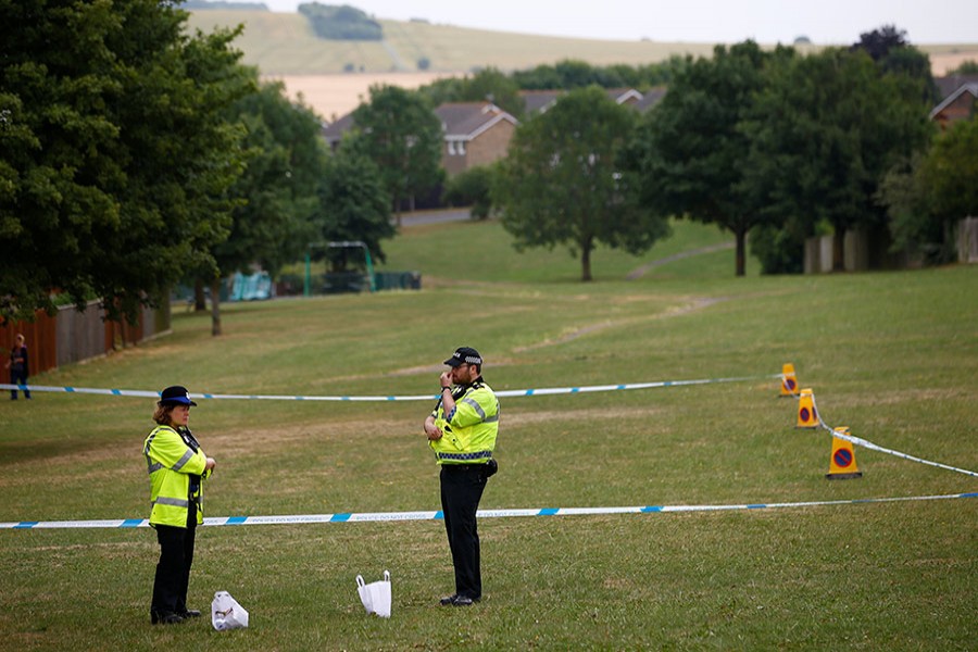 Police officers stand next to a section of playing field near Amesbury Baptist Church, which has been cordoned off after two people were hospitalised and police declared a 'major incident', in Amesbury, Wiltshire, Britain on Wednesday - Reuters photo