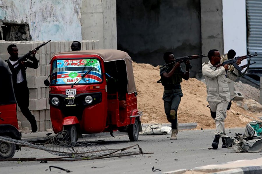 Somali security agents are taking position as they secure the scene of a suicide car bombing near Somalia's presidential palace in Mogadishu on Saturday. -Reuters Photo