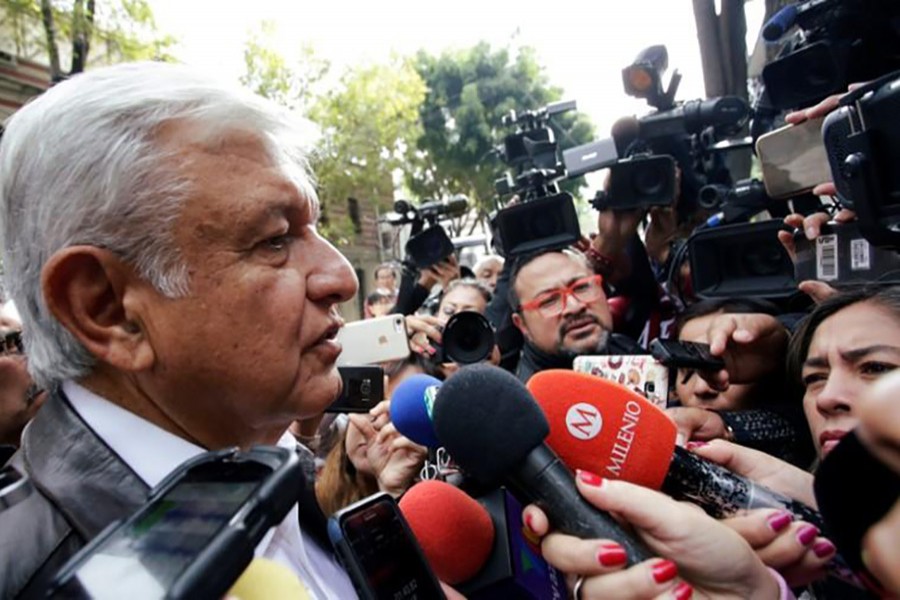 Mexican President-elect Andres Manuel Lopez Obrador talks to journalists as he arrives to a meeting with his new cabinet in Mexico City, Mexico on Saturday - Reuters photo