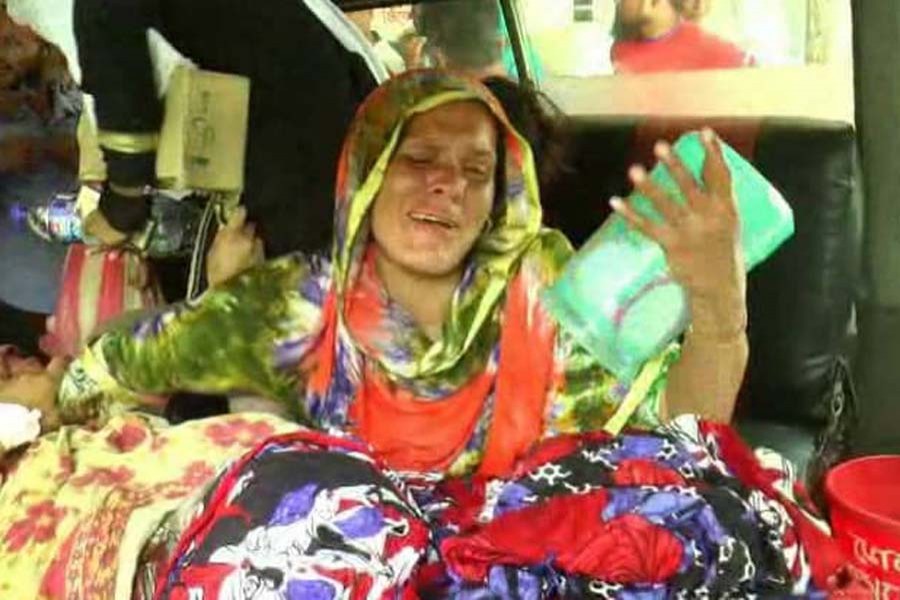 The mother of Bhola acid victims takes the sisters to CRP Hospital in Mirpur on May 17. Photo: UNB