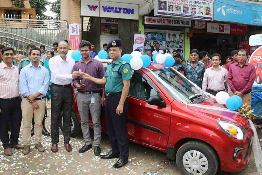 Amdadul Haque Sarker, executive director and head of marketing of Walton Group, is handing over the car’s key to Aradhon Chandra Saha in Dhaka