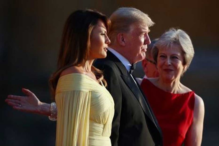 British Prime Minster Theresa May and her husband Philip stand together with US President Donald Trump and First Lady Melania Trump at the entrance to Blenheim Palace, where they are attending a dinner with specially invited guests and business leaders, near Oxford, Britain, July 12, 2018. - Reuters
