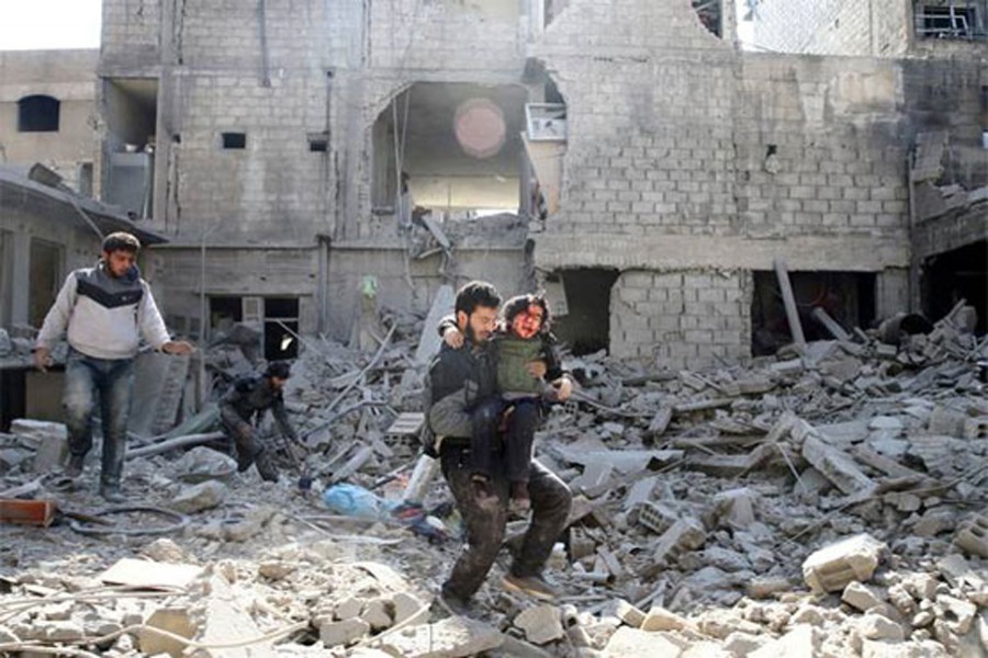 A man rescuing a baby from the debris in eastern Syria on Friday	— AP