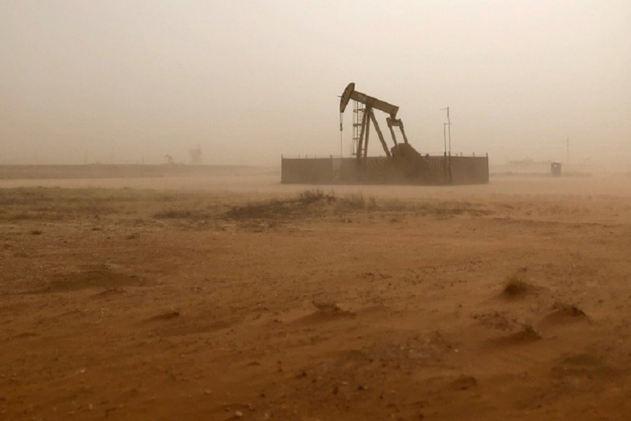 A pump jack lifts oil out of a well, during a sandstorm in Midland, Texas, US, April 13, 2018. Reuters/File Photo