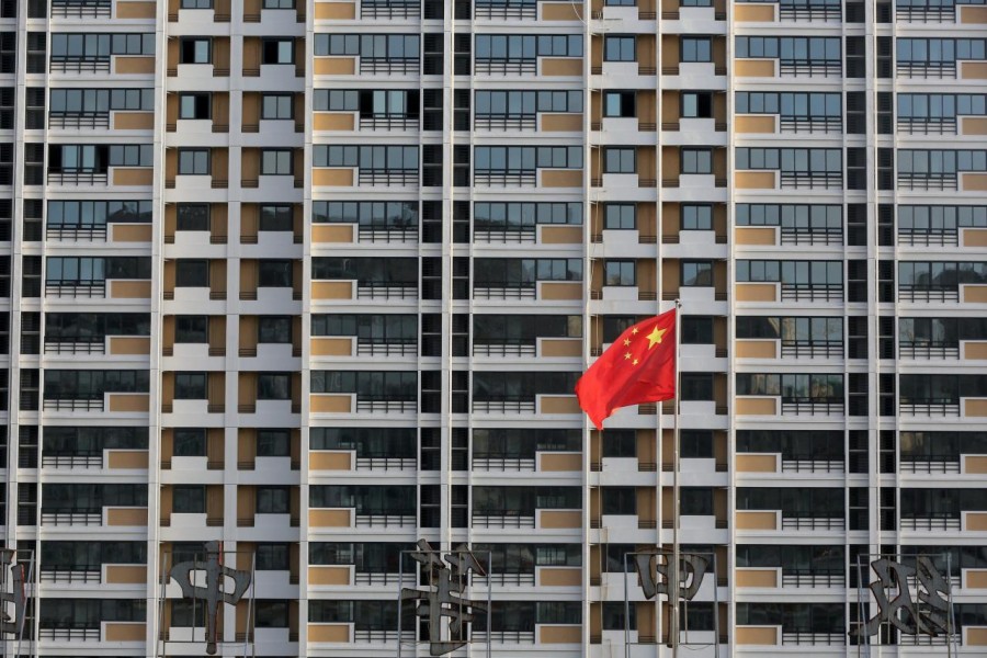 A Chinese flag flutters in front of a residential building under construction in Huaian, Jiangsu province, China July 12, 2018. Reuters/File Photo