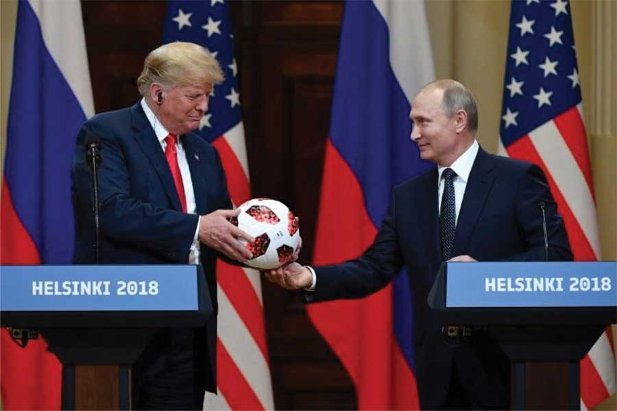 "Now the ball is in your court," President Vladimir Putin told President Donald Trump, handing him a ball from the 2018 World Cup at the joint press conference they addressed on July 16, 2018. 	—Photo: Yahoo News