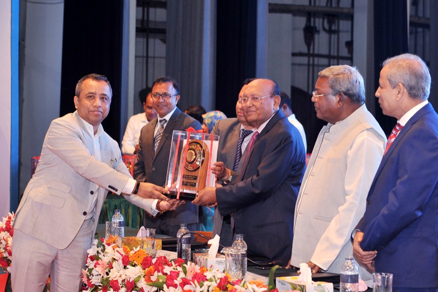 Deputy Managing Director of Abdul Monem Group and Chairman and Co-founder of ServicEngine A. S. M. Mohiuddin Monem receiving the National Export Gold Trophy from Commerce Minister Tofail Ahmed in the capital recently