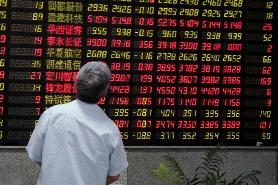 A man looks at an electronic board showing stock information at a brokerage house in Shanghai, China July 6, 2018. Reuters/Files