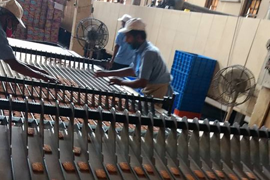 Workers seen on the production line at Nabisco Biscuit & Bread Factory in Dhaka — via Facebook