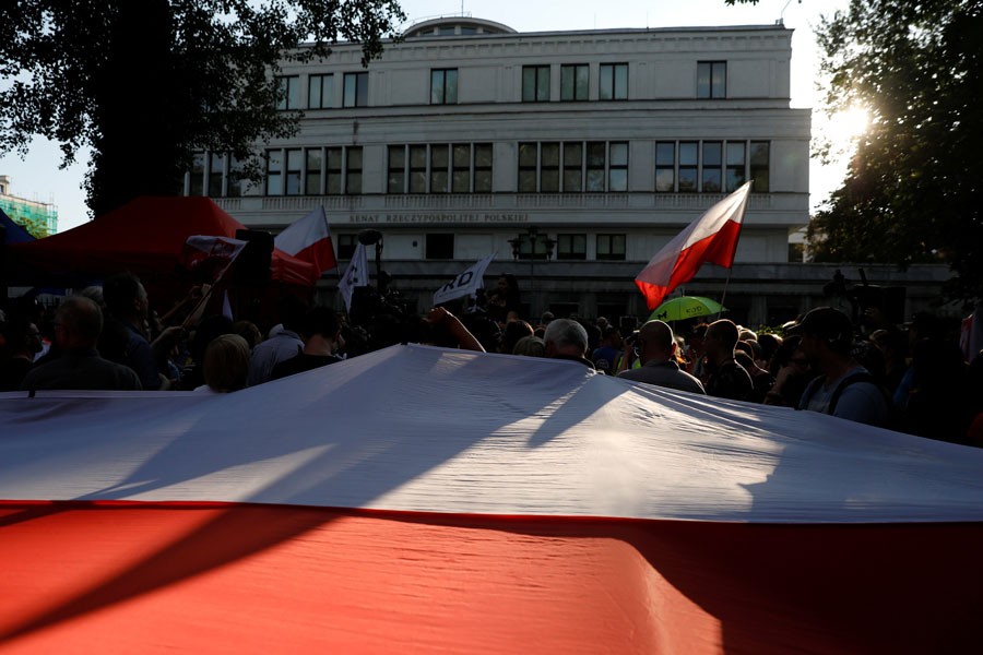 People gather during an anti-government protest in support of free courts in front of the the Senate building in Warsaw, Poland July 24, 2018- Reuters