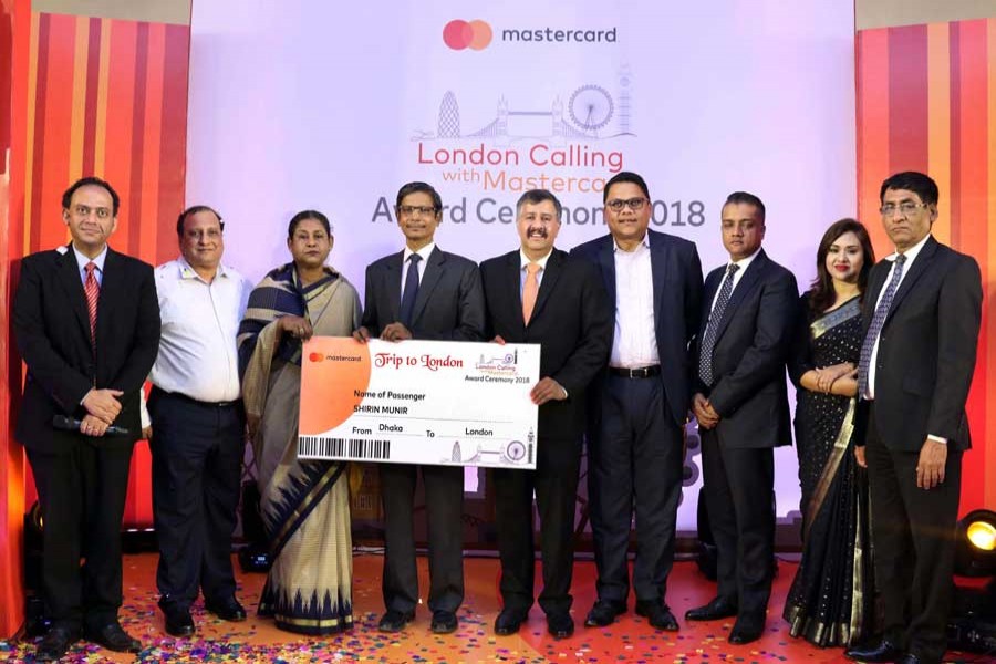 Top executives of MasterCard handing over the first prize to Ms Shirin Munir at a programme in the capital on Wednesday