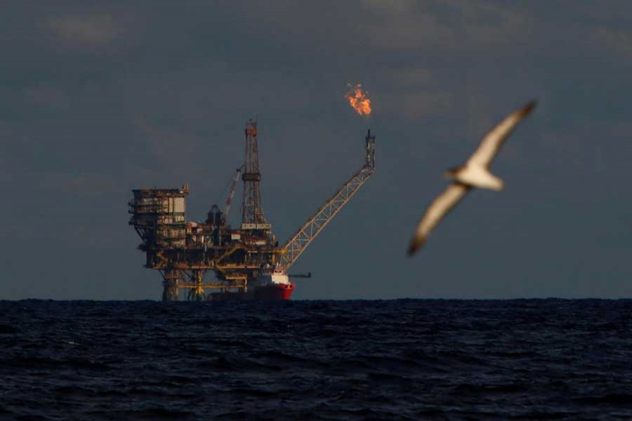 A seagull flies in front of an oil platform in the Bouri Oilfield some 70 nautical miles north of the coast of Libya, October 5, 2017. Reuters/Files