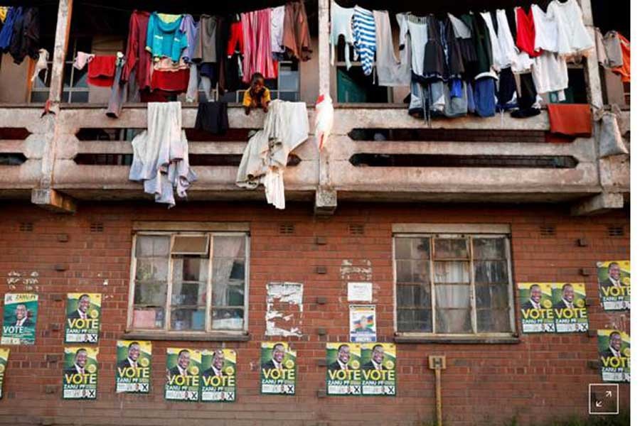 Election posters are pictured on the walls of apartments in Mbare township in Harare, Zimbabwe, July 29, 2018. Reuters