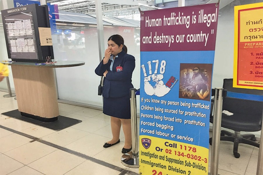 A banner with a message warning against human trafficking at Bangkok's main Suvarnabhumi Airport in Bangkok March 28, 2018. 	—Photo:  Thomson Reuters Foundation