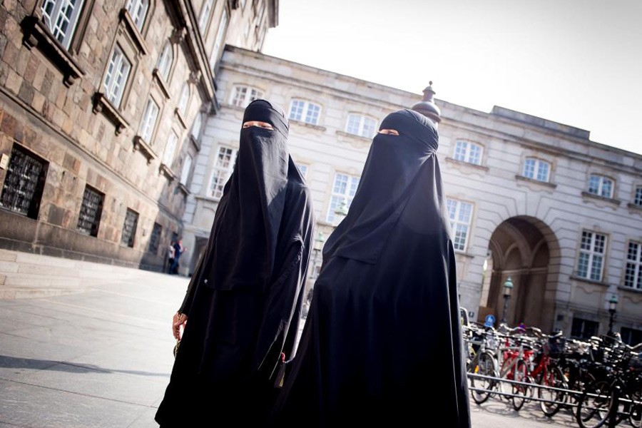 Women in niqab are pictured after the Danish Parliament banned the wearing of face veils in public, at Christiansborg Palace in Copenhagen, Denmark, May 31, 2018 – Reuters