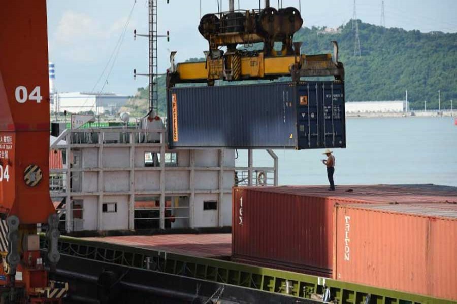 Shipping containers and cargo vessels are seen at the Dachan Bay Terminals in Shenzhen, Guangdong province, China July 12, 2018. Reuters/Files