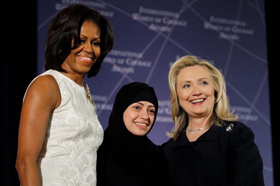 US Secretary of State Hillary Clinton and First lady Michelle Obama (L) congratulate Samar Badawi of Saudi Arabia during the State Department's 2012 International Women of Courage Award winners ceremony in Washington Mar 8, 2012. Reuters file photo