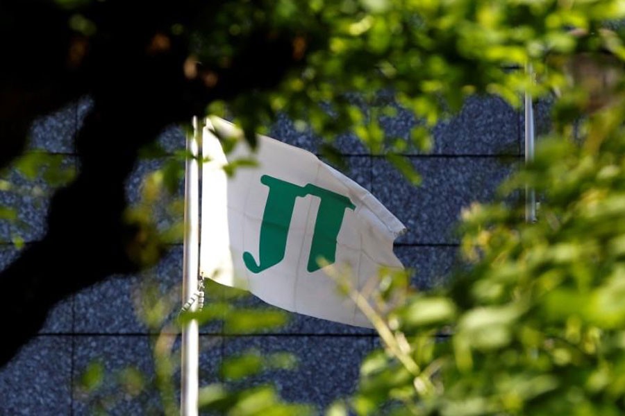 The flag of Japan Tobacco Inc (JT) is seen outside the company's headquarters building in Tokyo, Japan, May 18, 2016 - Reuters