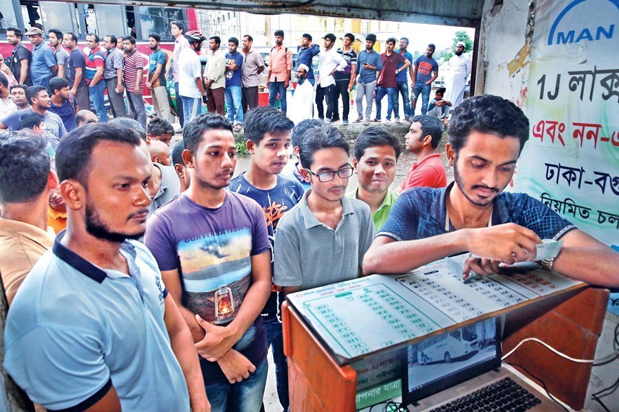 City dwellers queueing up at the Gabtoli bus terminal in the city on Tuesday to buy advance tickets for going home as they plan to celebrate the Eid-ul-Azha back in their villages — FE Photo