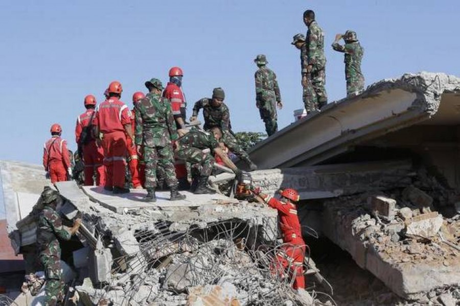 Rescuer teams continue to search for victims in the collapsed Jamiul Jamaah Mosque in Bangsal, North Lombok, Indonesia, on Aug. 8, 2018.   | Photo Credit: AP