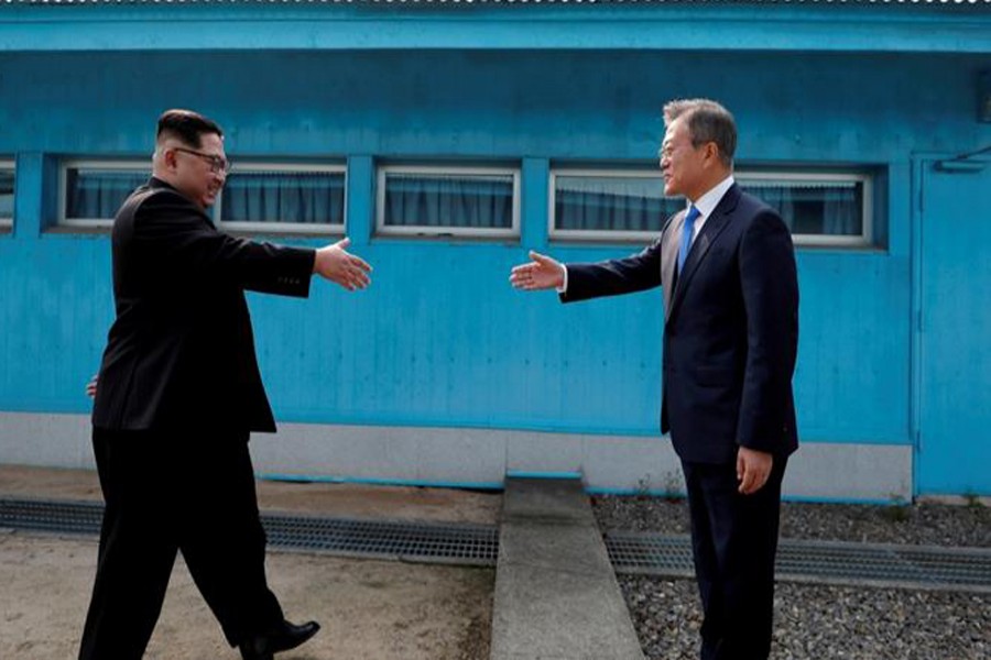 A file photo showing Kim Jong-un and Moon Jae-in	— Reuters