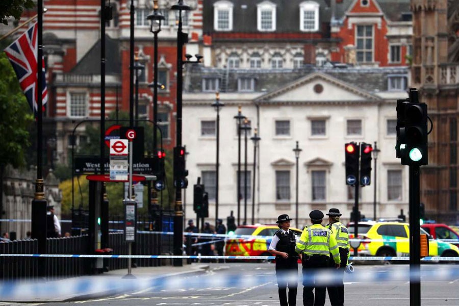 Police stand in the street after a car crashed outside the Houses of Parliament in Westminster, London, Britain, August 14, 2018 – Reuters