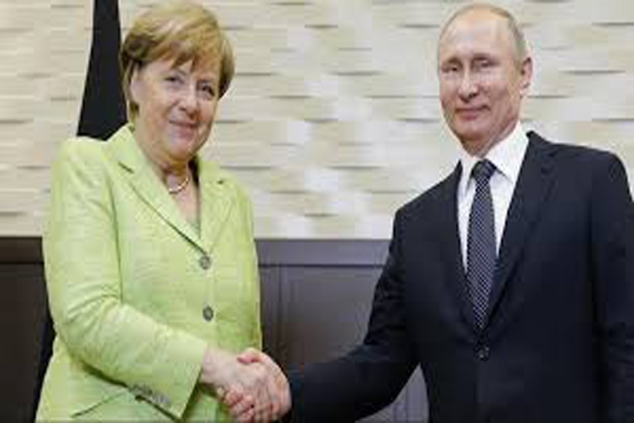 A file photo showing German Chancellor Angela Merkel shaking hands with Russian President Vladimir Putin recently	— Reuters