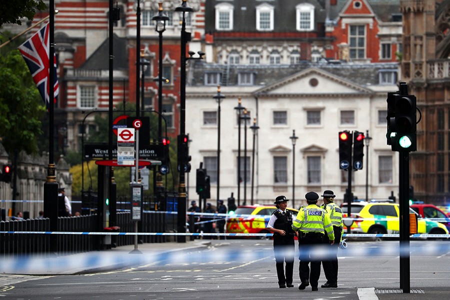 Police stand in the street after a car crashed outside the Houses of Parliament in Westminster, London, Britain on Tuesday — Reuters