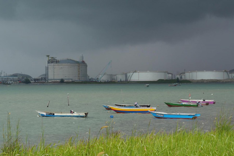 Dark clouds pull up over an oil storage terminal in Johor, Malaysia	— Reuters