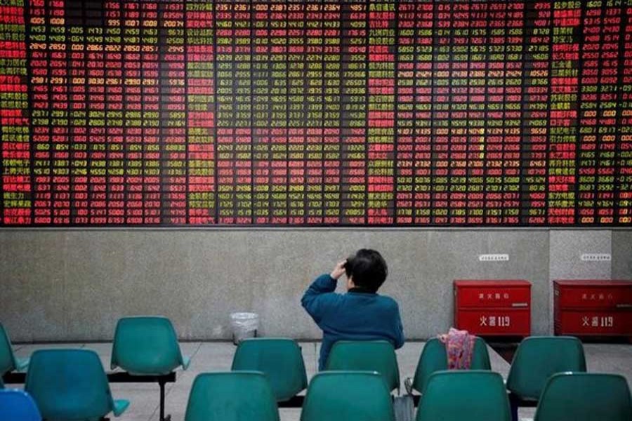 An investor looks at an electronic board showing stock information at a brokerage house in Shanghai, China November 24, 2017. Reuters/File Photo
