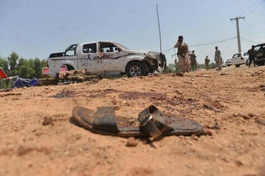 Security personnel inspect the side of a suicide attack near the office of the Election Commission in Jalalabad city, capital of eastern Nangarhar province, Afghanistan, on Saturday. At least two people were killed and four others injured in the attack. – AP photo