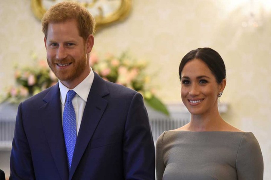 Britain's Prince Harry and his wife Meghan, Duchess of Sussex, smiling