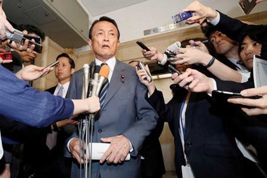 Japan's Deputy Prime Minister and Finance Minister Taro Aso speaks to reporters at the Finance Ministry in Tokyo, Japan in this photo taken by Kyodo April 18, 2018. Reuters/Files