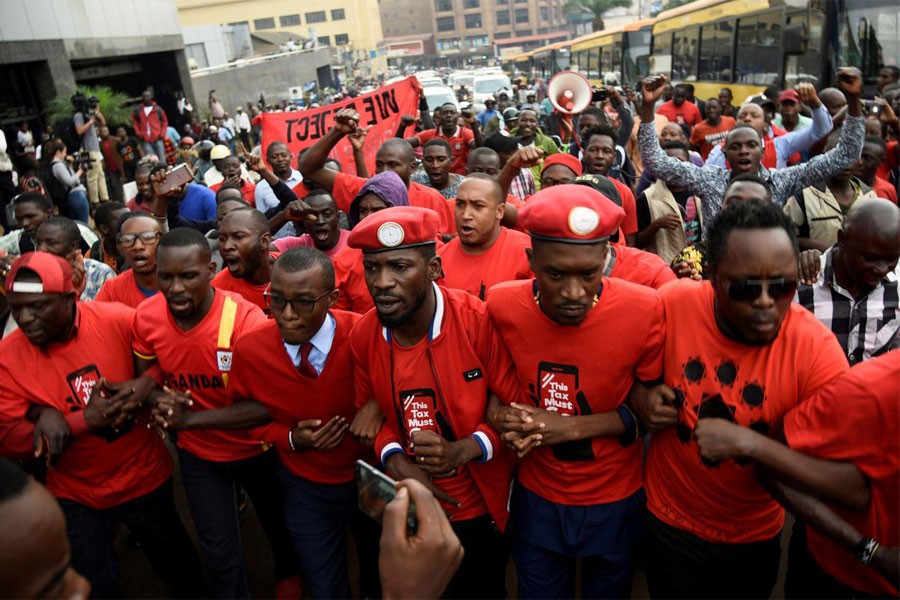 Ugandan musician turned politician, Robert Kyagulanyi (C) leads activists during a demonstration against new taxes including a levy on access to social media platforms in Kampala, Uganda July 11, 2018 – Reuters file photo