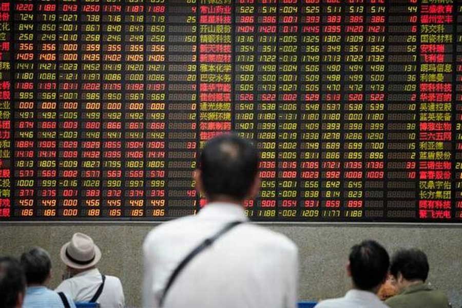 People look at an electronic board showing stock information at a brokerage house in Shanghai, China July 6, 2018. Reuters/Files