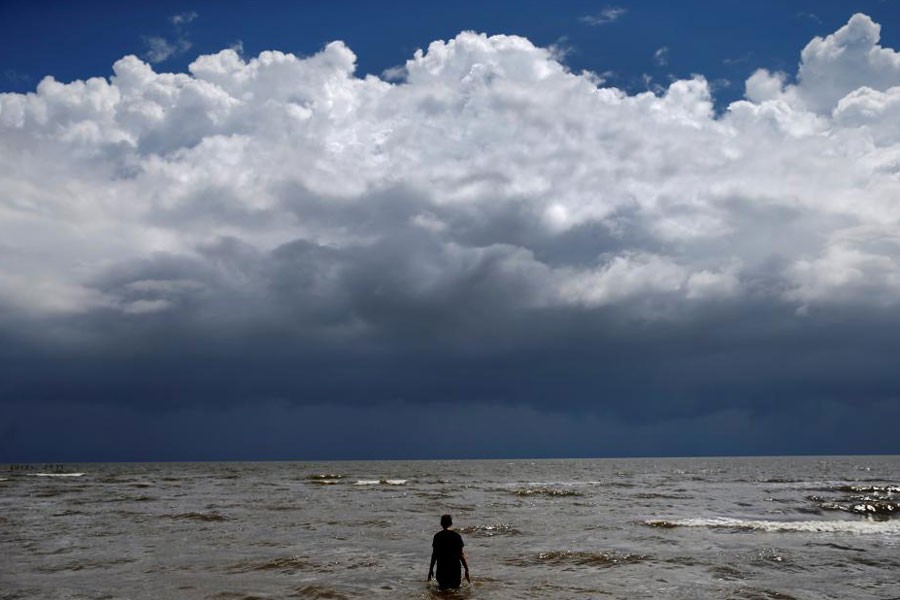 15-year-old Jordan Carambat wades in the ocean as Tropical Storm Gordon approaches Waveland, Mississippi, US, September 4, 2018 – Reuters