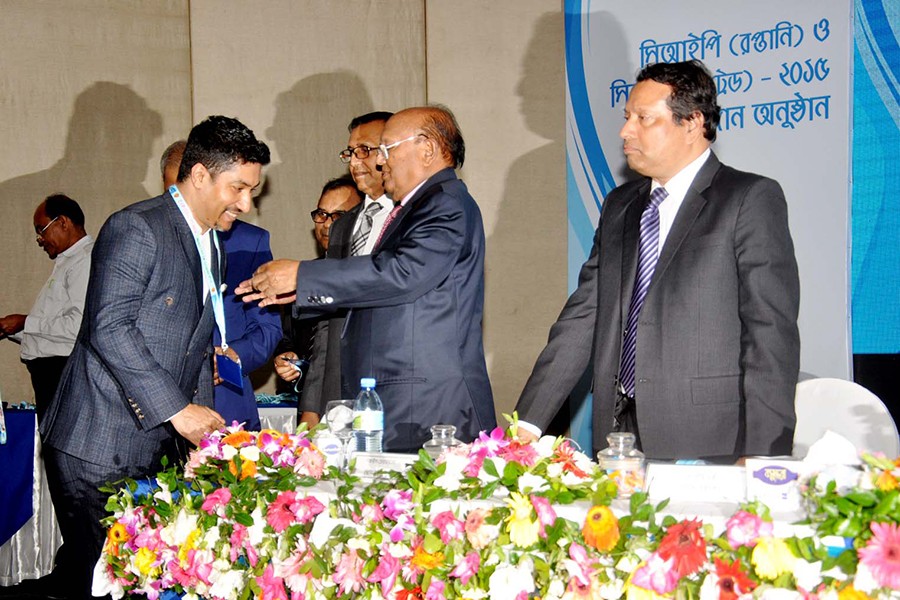 Shameem Ahsan, Chairman of eGeneration Group and a director of FBCCI, receiving the CIP award from Commerce Minister Tofail Ahmed for his contribution to the country's ICT sector.