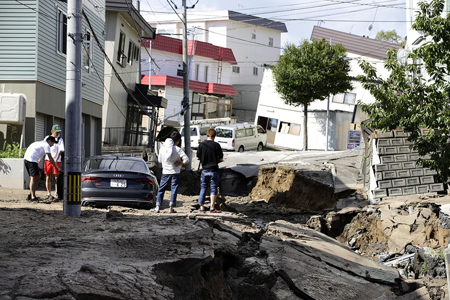 People look at an area damaged by an earthquake in Sapporo in Japan's northern island of Hokkaido, Japan on Thursday — Kyodo photo via Reuters