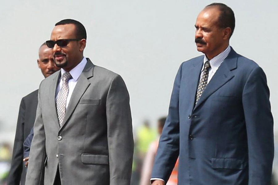 Eritrea's President Isaias Afwerki (R) is welcomed by Ethiopian Prime Minister Abiy Ahmed upon arriving for a three-day visit, at the Bole international airport in Addis Ababa, Ethiopia on July 14, 2018 - Reuters