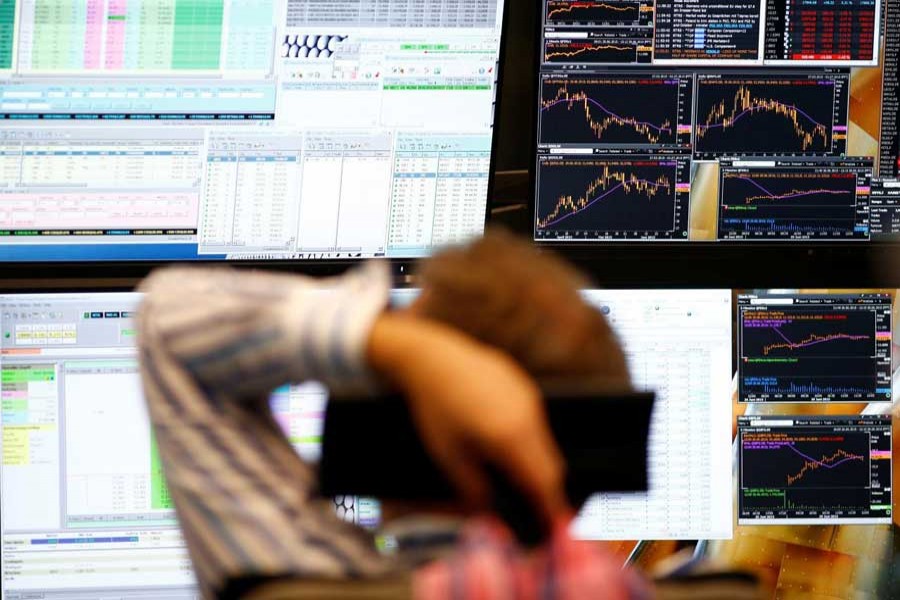 A trader sits in front of the computer screens at his desk at the Frankfurt stock exchange, Germany, June 29, 2015. Reuters/Files