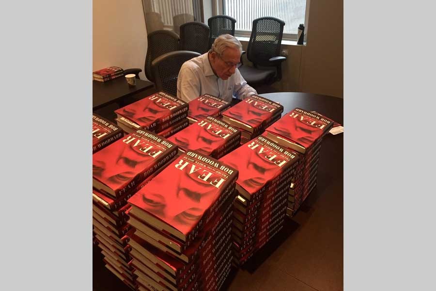 Bob Woodward signs copies of 'Fear: Trump in the White House,' in a photo, the author tweeted, a day after the book's release