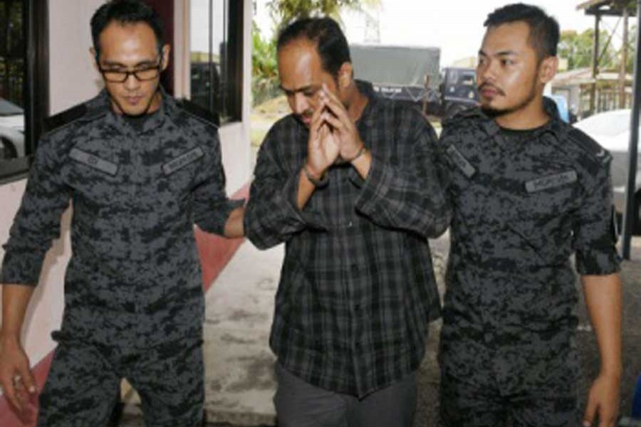 Bangladeshi labourer Md Mohiuddin Mamun, 40, (C) was sentenced to six years and eight months' jail, as well as a fine of RM30,000, in default six months' jail, and two strokes of the cane by the Immigration sessions court in Pekan Nanas  on Monday — Bernama