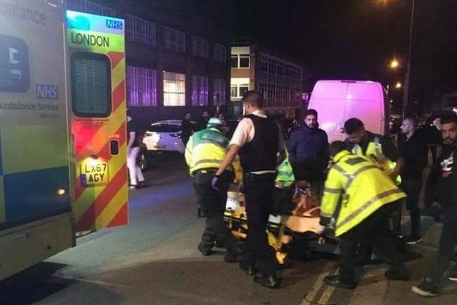 Paramedics wheel an injured person into an ambulance – Twitter photo