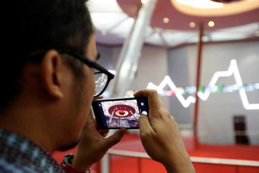 A man takes pictures inside the Indonesia Stock Exchange building in Jakarta, Indonesia, September 6, 2018. Reuters/Files